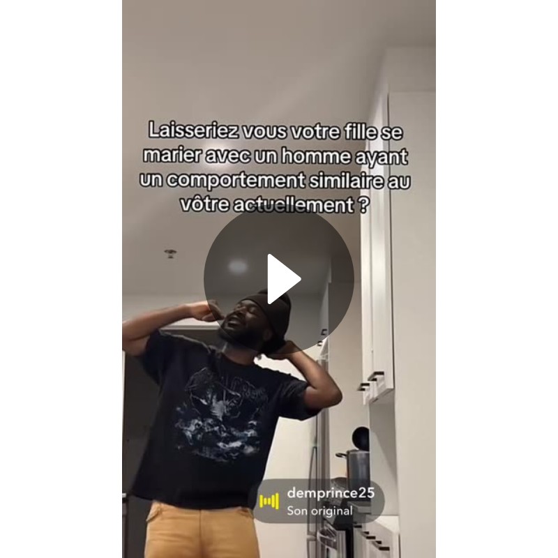 Man in Black Graphic T-Shirt and Beanie in Modern Kitchen